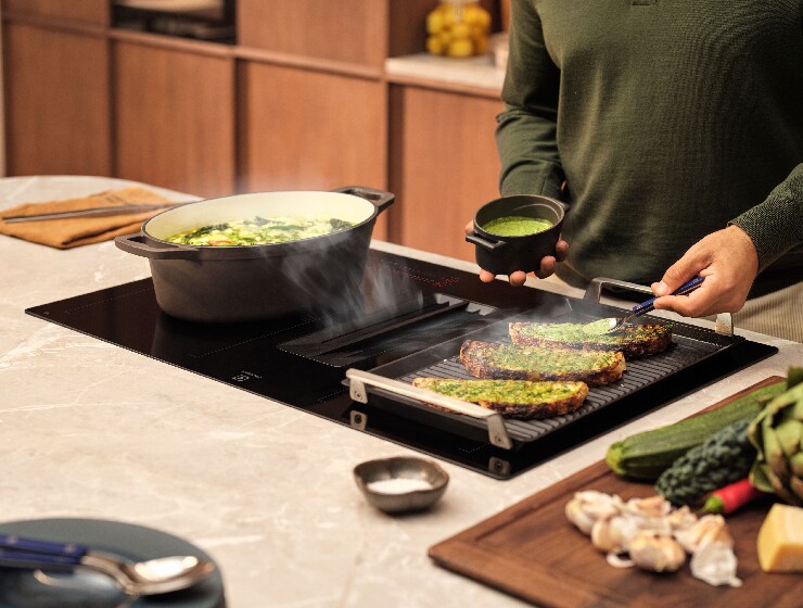 Mees valmistab köögis toitu.