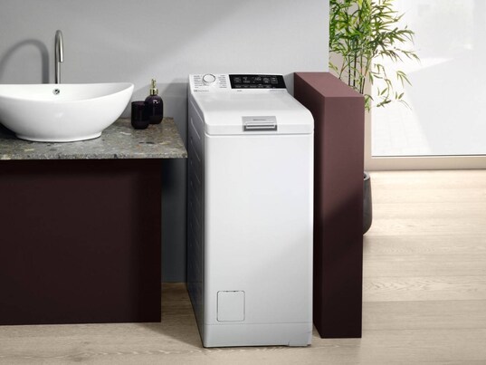 Top loaded washer - white washing machine with sink next to it